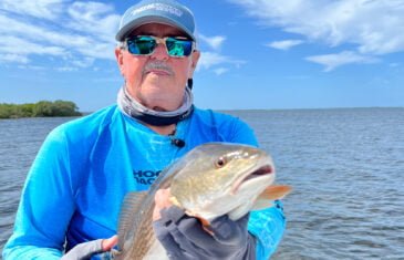 Captain Sergio Atanes holding a fish he caught