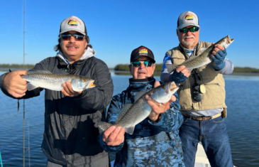 Capt Sergio, Capt. George and guest Capt. Larry Fritch holding trout the have caught