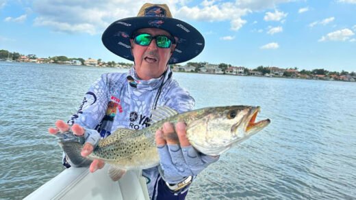 Angler displaying spotted sea trout catch during Fort DeSoto fishing expedition