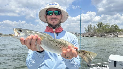 Angler holding spotted trout caught in Tampa Bay