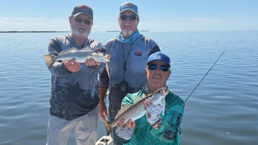 Anglers on a Catching Everything Crystal River fishing trip holding trout they caught