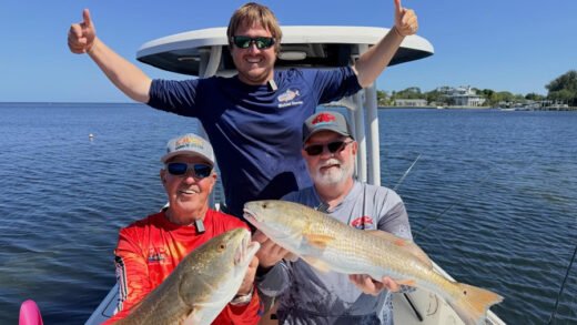 Captain Sergio Atanes and guests holding trout and redfish in Tarpon Springs