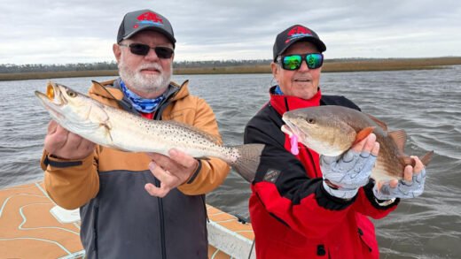 Captain Sergio Atanes and angler holding speckled trout and redfish in Steinhatchee Florida